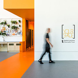A man walking in a hallway.